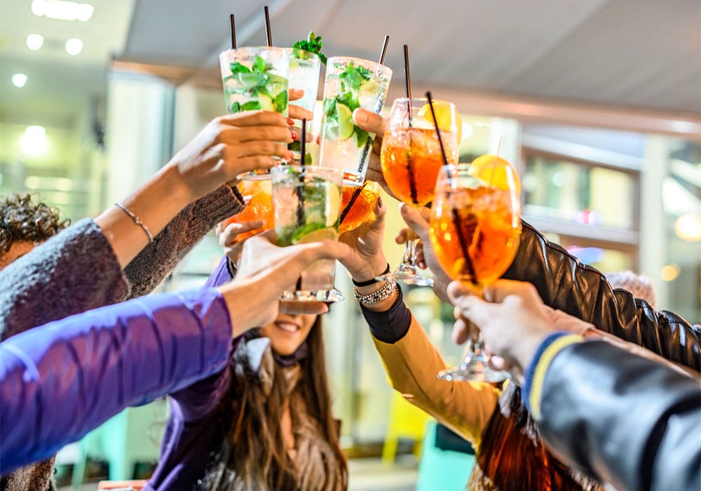 Group of people toasting with cocktails