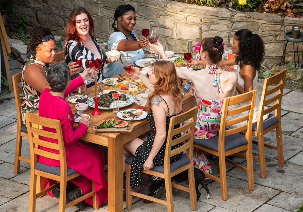 Group of women enjoying their meal on an outdoor patio.