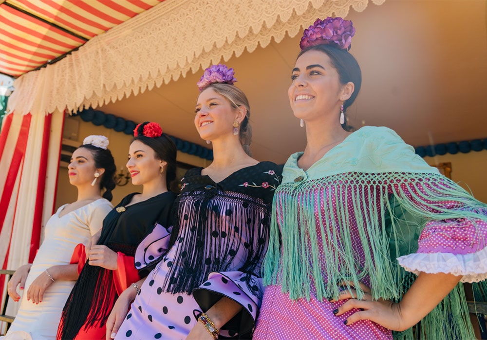 Group of women dressed in flamenco style outfits at a Final Fiesta themed party.