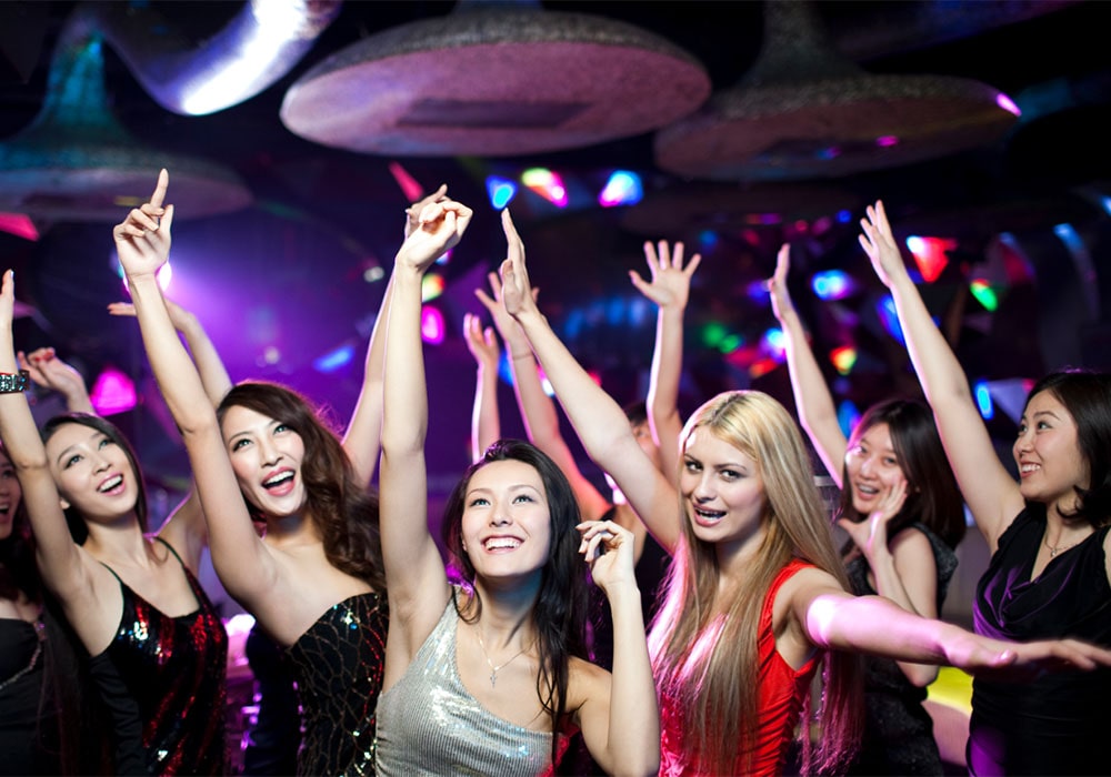 Group of cheerful young women dancing in a club.